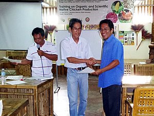 A participant receiving his certificate of completion from Dr. Arsenio D. Calub, Project Leader.