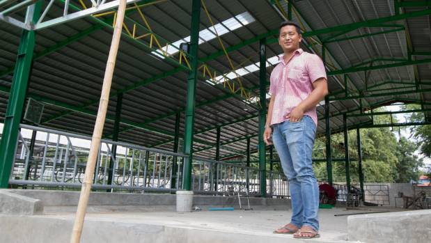 Dairy farmer U Kyan Shone Kyin, 24, standing in his new feeding barn Kyan Shone Kyin's Shwe Oh Dairy Farm was one of the original "focus farms" the New Zealand dairy aid project offered assistance.