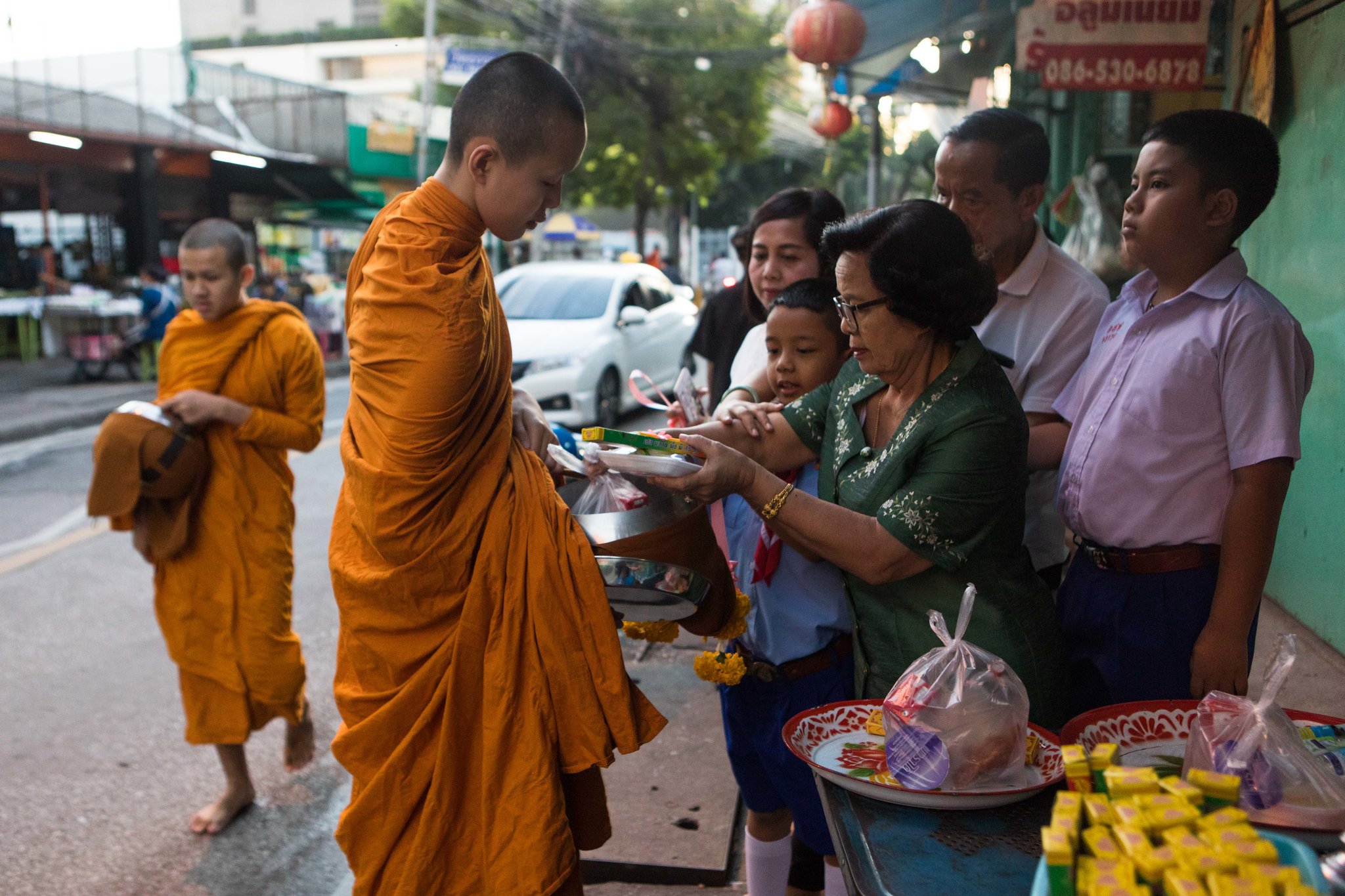 Young monks during almsgiving in Bangkok last month. Almost half of Thailand’s monks are obese, and the government is urging people to give them healthier food.CreditAmanda Mustard for The New York Times